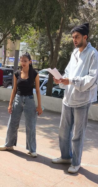 Two teammates reading a script outdoors