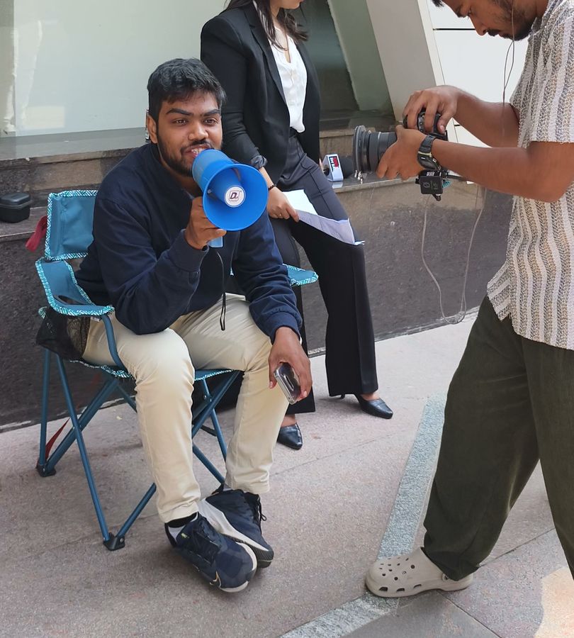 The crew on an outdoor shoot with a camera and a megaphone